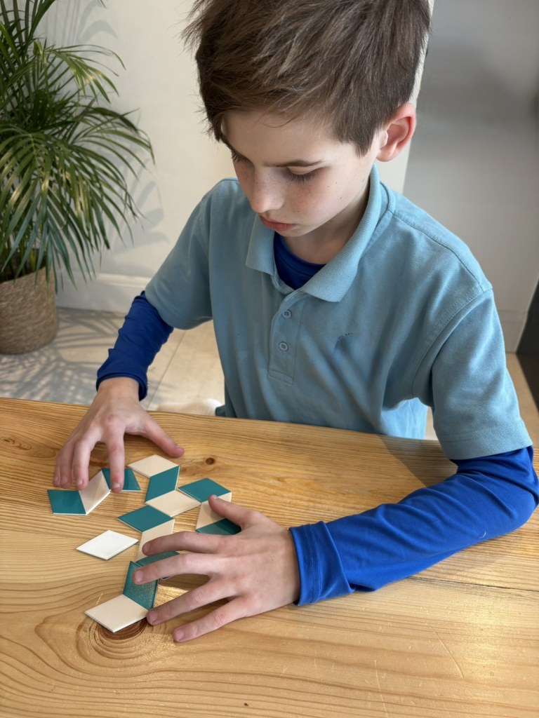 A primary school child working on a hands-on activity